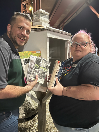 NW PA Pride Alliance President Alex Sphon and board member Juilie Lebow help distribute some of the 474 queer books to one of the Little Free Library System's libraries in Erie and Crawford County.