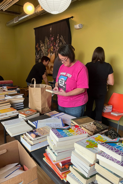 Kim Perrine, co-chapter leader of Erie's Free Mom's Hugs helps in sorting the 474 queer-themed books that were collected.