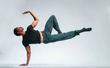 Male dancer balancing on 1 arm horizontal